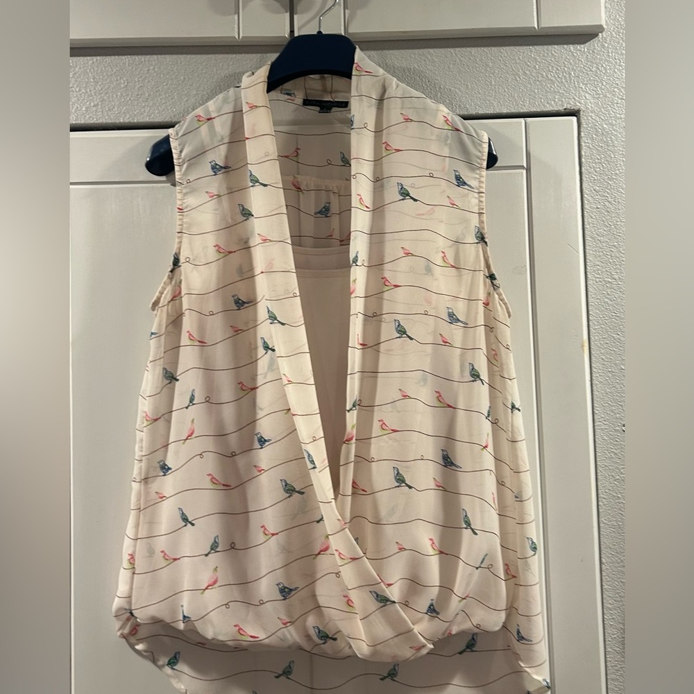 Used in good condition. Sleeveless blouse